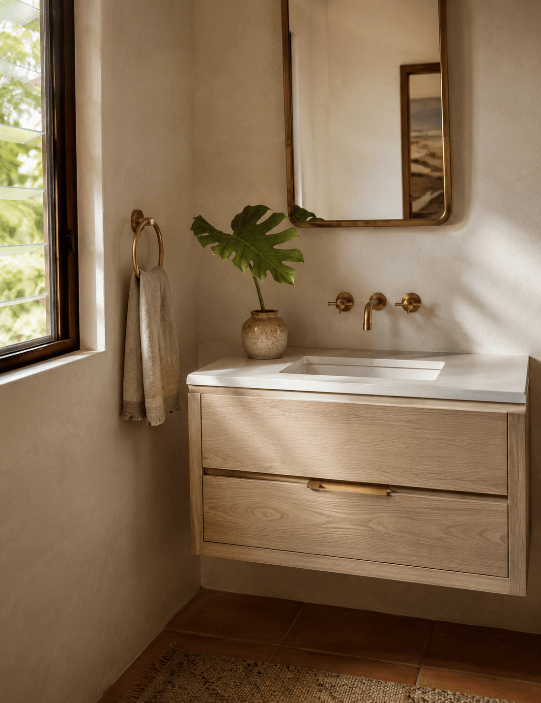 Custom floating white oak bathroom vanity with brass fixtures